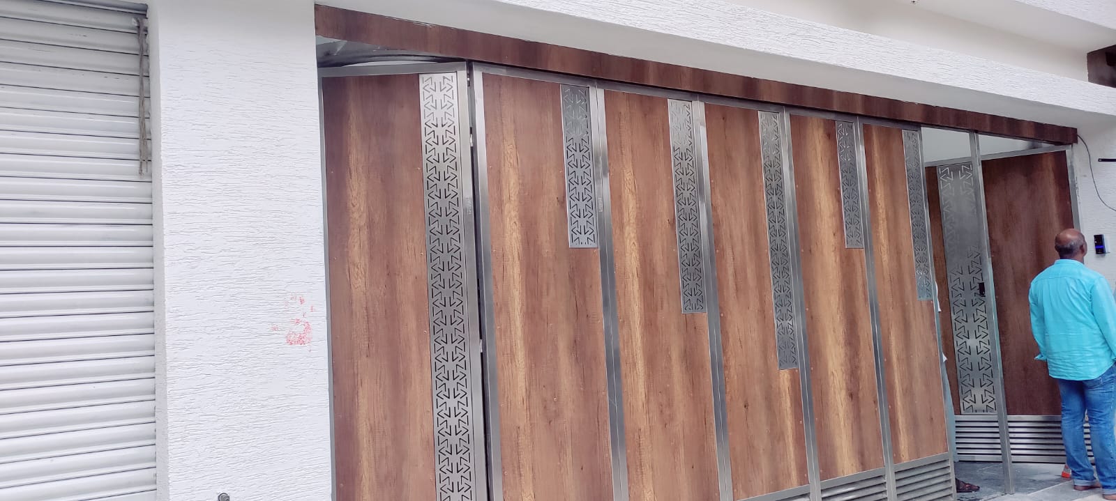 Timber-finish sliding gate with patterned steel details